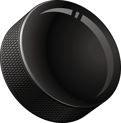 A black circular hockey puck .