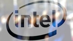Intel Corporation logo on a glass against blurred crowd on the steet.  Editorial 3D rendering