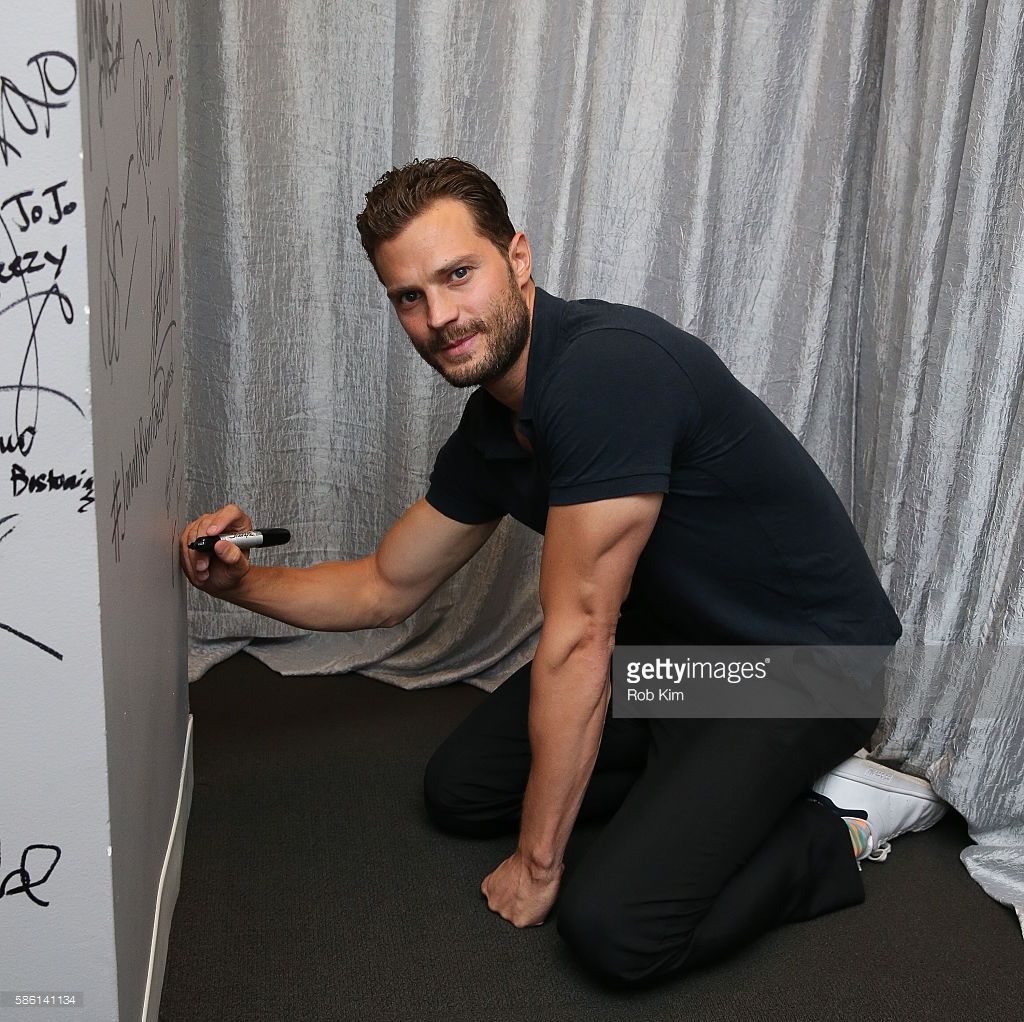 Jamie Dornan signs the wall at AOL Build at AOL HQ on August 5, 2016