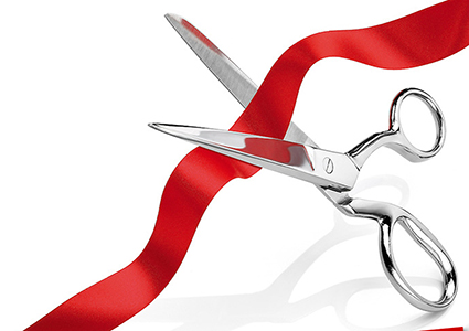 ... scissors cutting red ribb