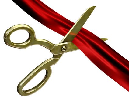 ... scissors cutting red ribb