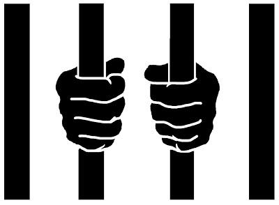 ... hands holding prison bars